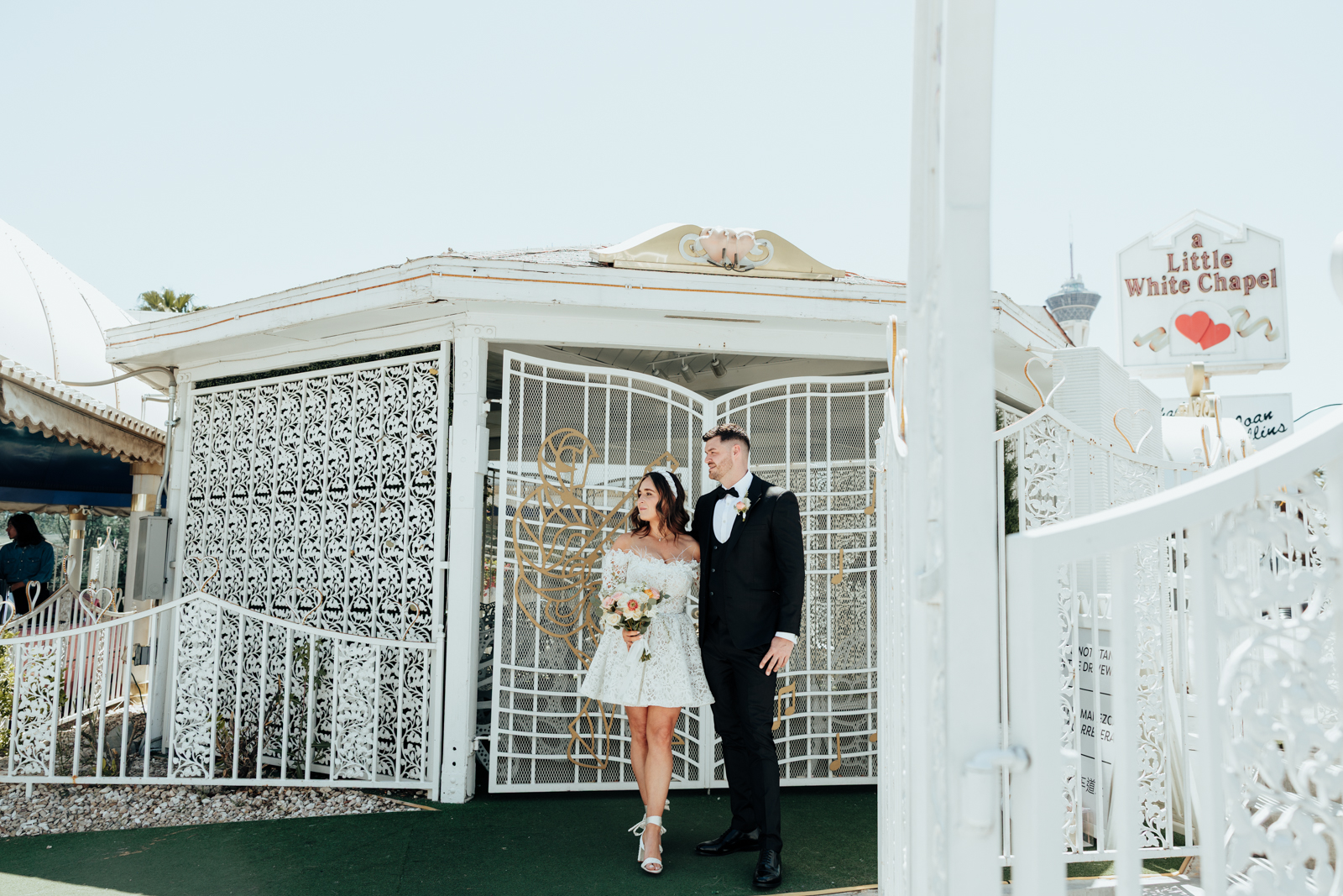 couple stanging outside Little White Wedding chapel waiting to get married